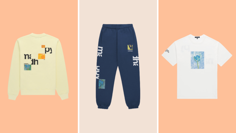 The back of a printed yellow sweatshirt, a pair of blue sweatpants, and a white t-shirt with a print on it.