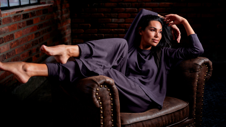 An image of a woman in a navy blue lounge set with soft pants and a soft, loose top.