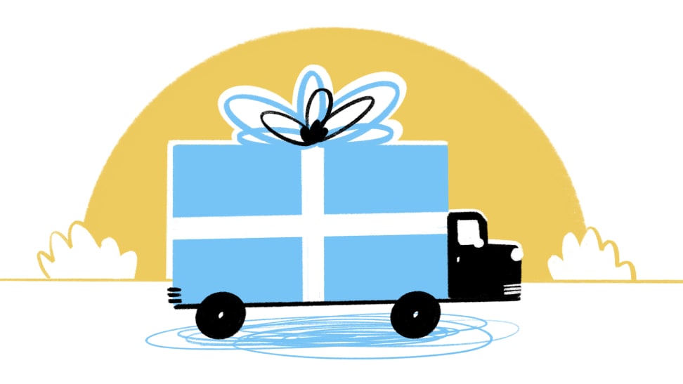 A blue truck driving with a gift bow on top of it