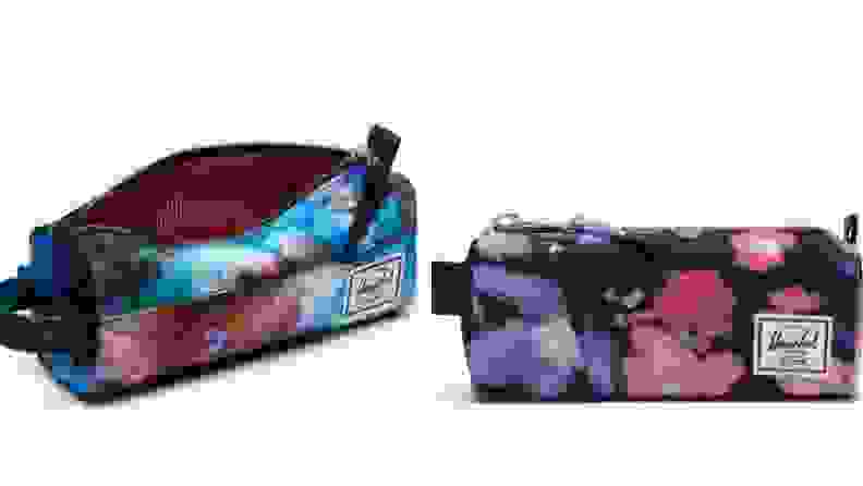 On left, blue cosmic pencil pouch. On right, black, pink and purple floral pencil case.