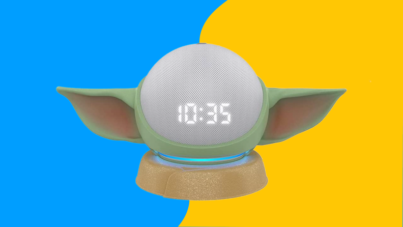 A baby Yoda shaped alarm clock with LED time display.