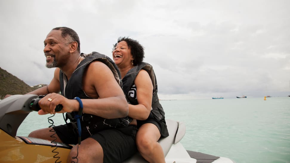 Retired couple riding together on a jet ski