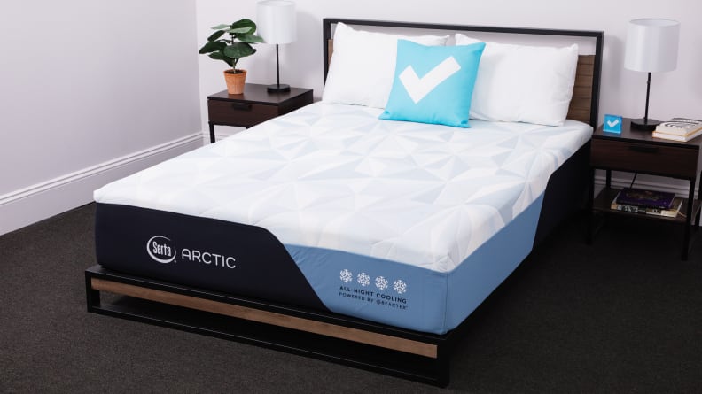 The Serta Arctic mattress appears in a bedroom with bedside tables on either side.