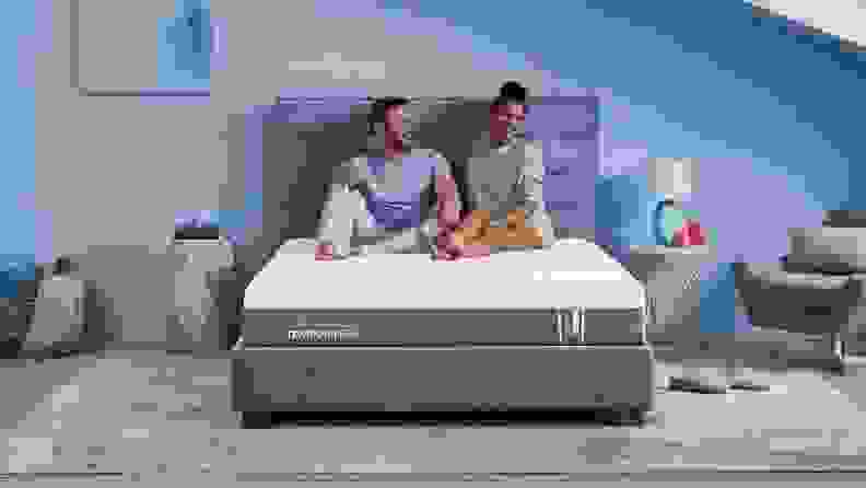 a couple sits on the tempur-pedic mattress