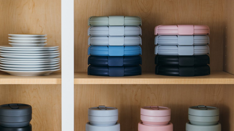 In a cabinet, stacks of Stojo bowls and cups are on display.