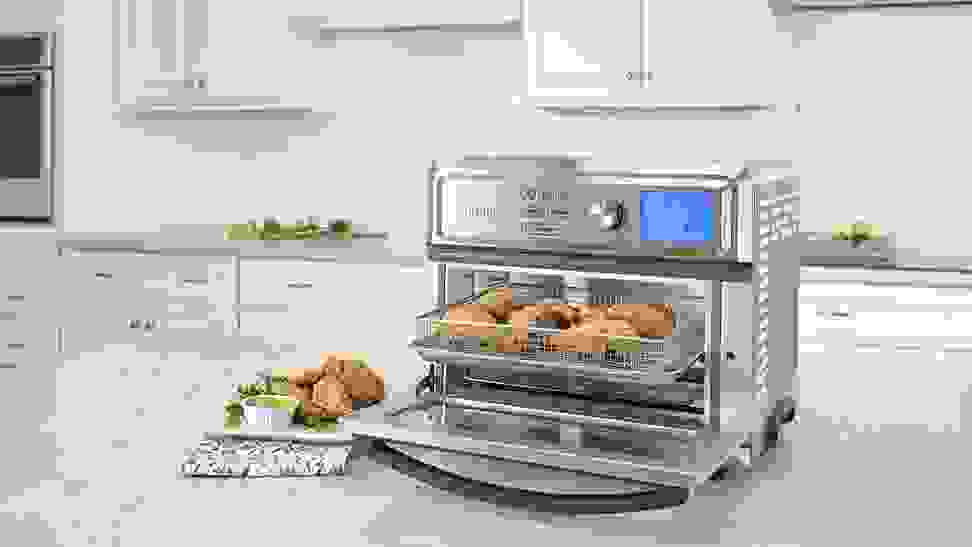 A Cuisinart Toaster Oven is being used on a kitchen table.