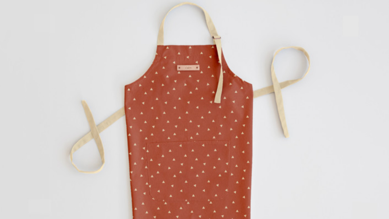 An image of a russet-colored apron on a white background.