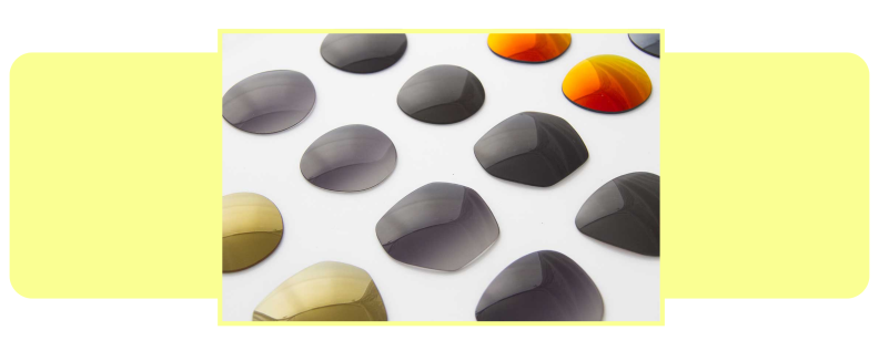 Sunglass lenses laid out on a white surface.