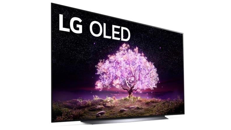 An LG OLED television shows a pink-and-purple image of a magical tree.