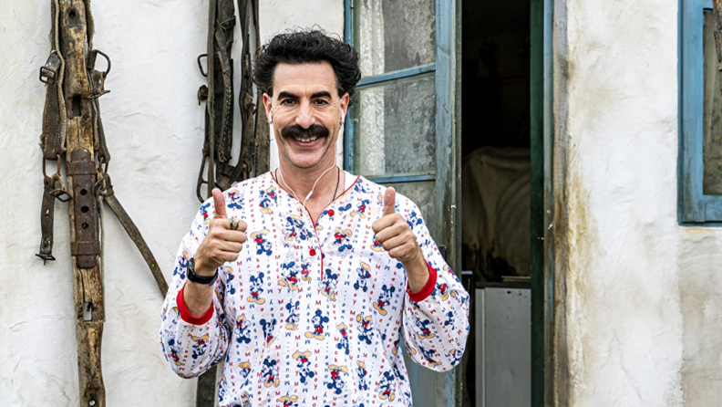 A still from the film Borat 2 featuring Sacha Baron Cohen smiling.
