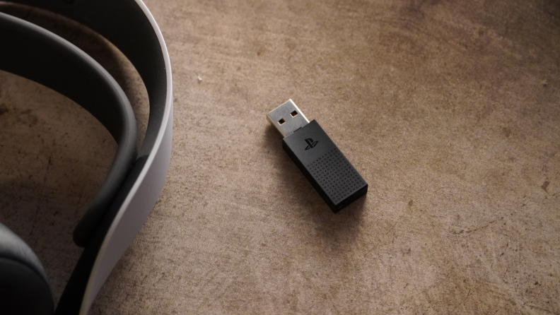The headset USB dongle with the PlayStation logo.