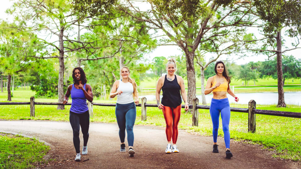 Four women walking in a park