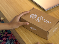 Person holding a box from HP Instant Ink