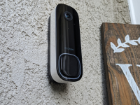 The Ecobee Smart Doorbell Camera hanging on the outside of a house.