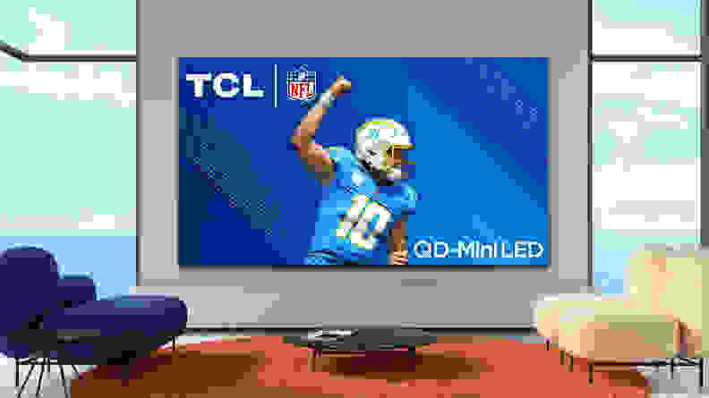 The TCL QM8 mini-LED TV displaying a professional football player in a modern living room