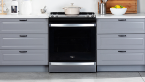 The Whirlpool WEE745H0LZ Electric Range in a modern kitchen between two sets of drawers.