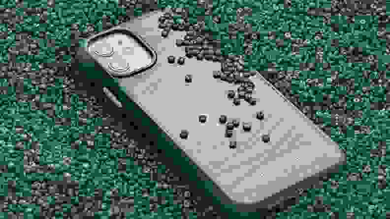 A protective green phone case surrounded by green beads.