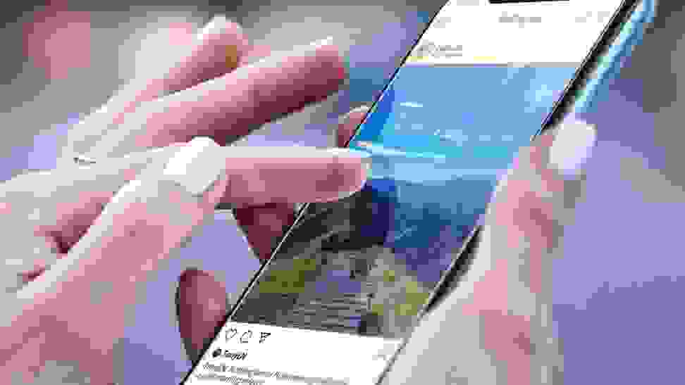 Close-up of a hand model using a smartphone with a touchscreen