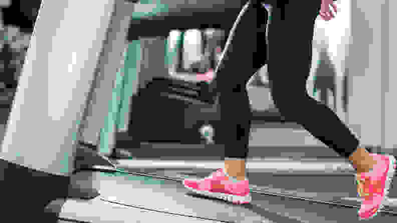 An image of a woman's legs as she walks on a treadmill.