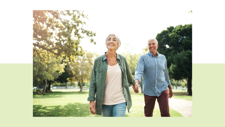 A middle aged couple walking in a park.