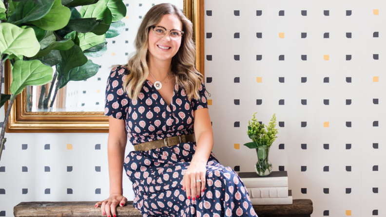 Designer Meg Piercy sits in front of a mirror