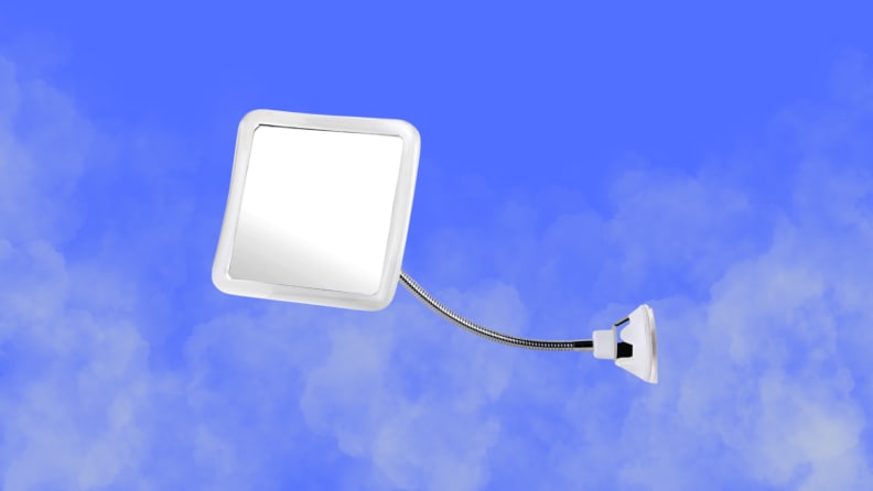 A shower mirror sits on a steamy blue background background