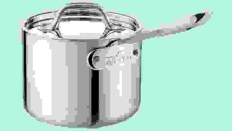 An All-Clad pot against a blue background.