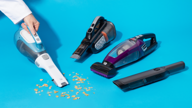 A group of handheld vacuums on a blue background