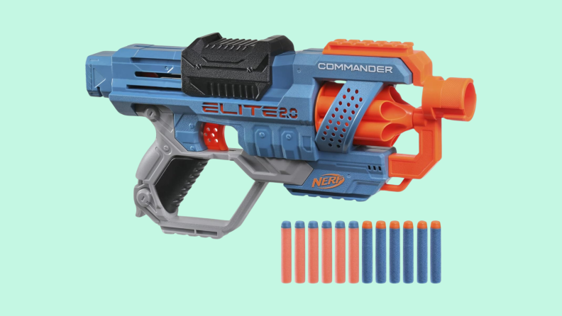 The blue-gray Nerf Elite 2.0 Commander gun hovering above 12 Nerf darts.
