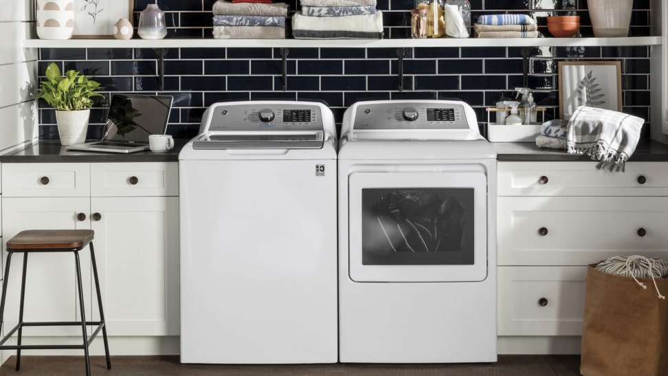 A GE top-load washer and its paired dryer in a modern laundry room.