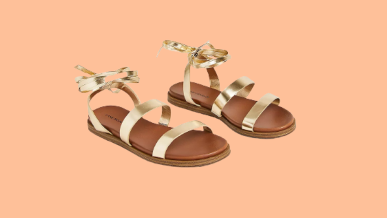 A pair of flat gold gladiator sandals.