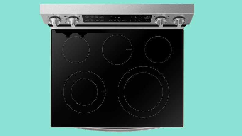 Close up of a stovetop of a stainless steel electric range.