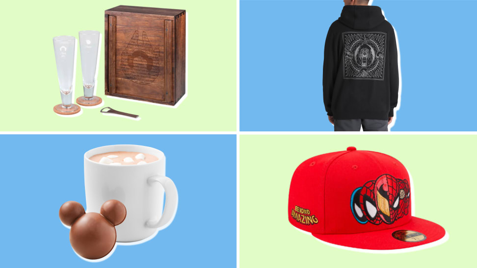 A set of two pilsner glasses with a wooden box; a black hoodie with a graphic of Scar from "The Lion King," a hot chocolate bomb shaped with the Mickey Mouse ears in front of a mug of hot chocolate; a red flat-brimmed baseball cap with a logo of Spider-Man on the front.