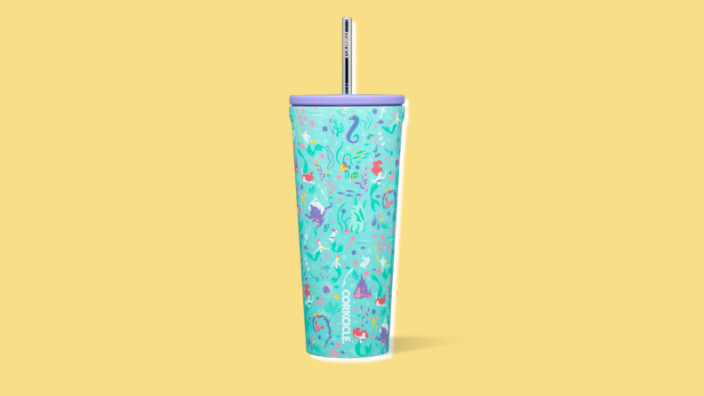 A turquoise drink tumbler with a repeating pattern of stylized characters from "The Little Mermaid"