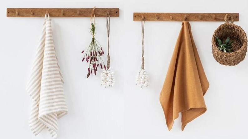 Two brown and cream linen towels hanging from mounted coat rack on wall.