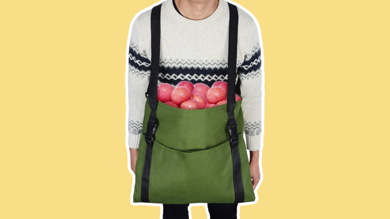 A man wearing the V&H Fruit Picking Bag.