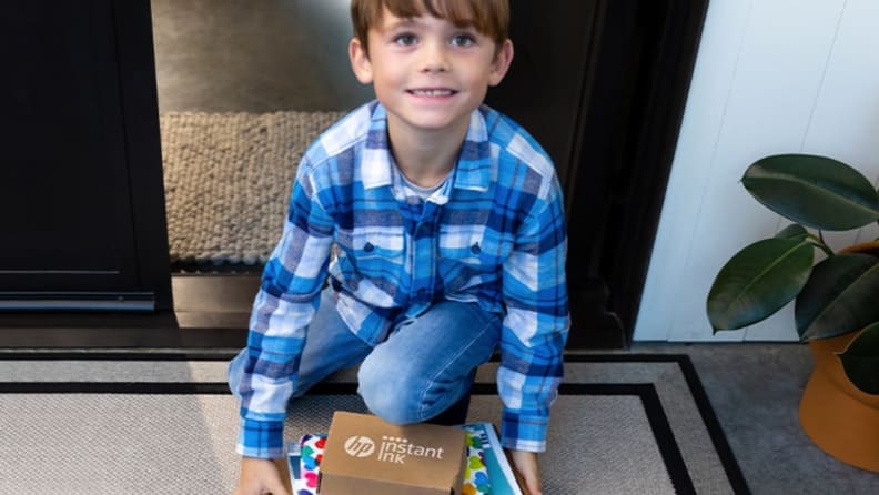 A child receiving an HP ink package.
