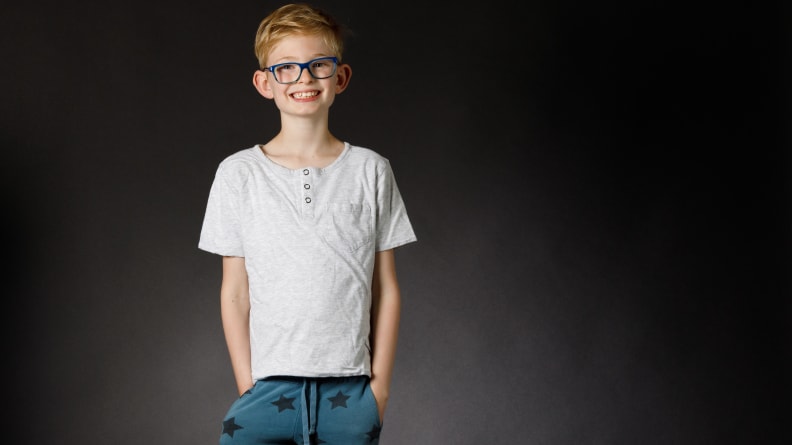 A young boy smiling and wearing a T-shirt