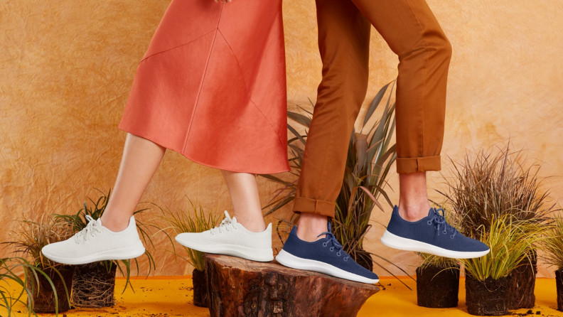 Man and woman wearing sneakers in earth tones.
