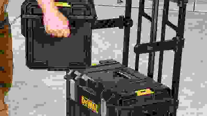 A person carries a tool kit.