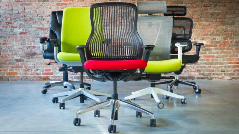 A lineup of colorful office chairs.