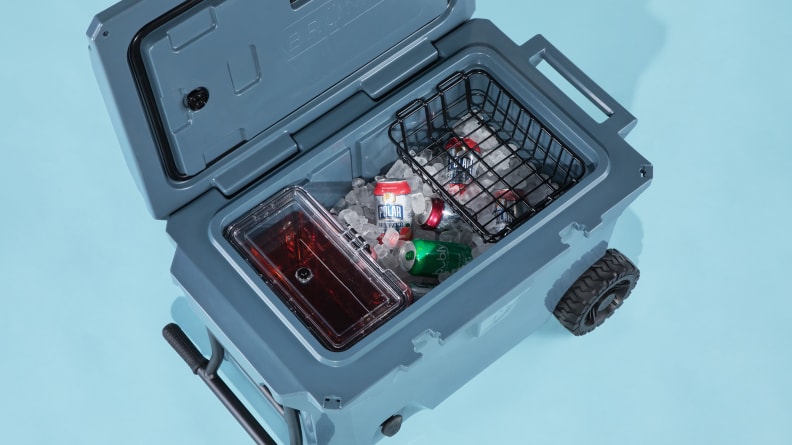 A rolling Brumate cooler sits on a blue background.