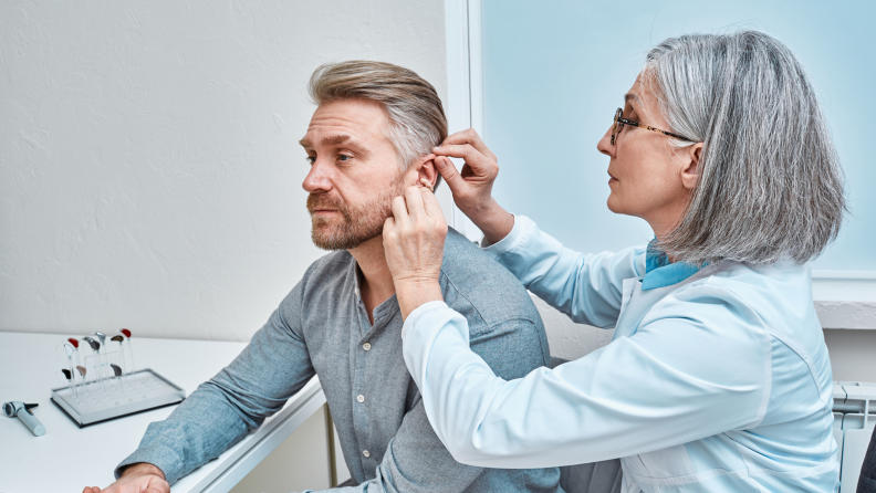 Man being fitted for hearing aid