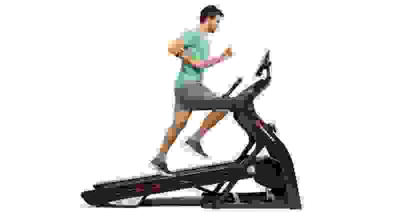 A man running on an elevated treadmill.