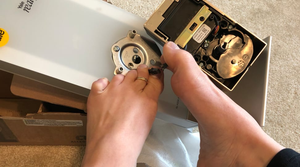 Sarah using her feet to install smart locks