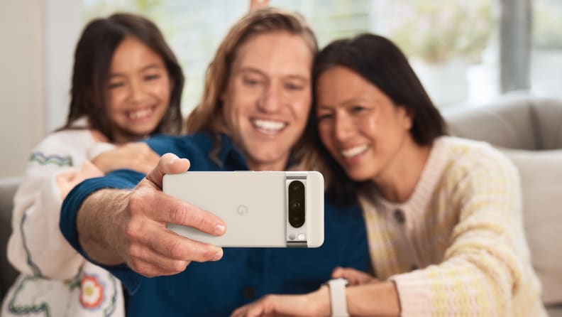 A man taking a selfie with his family on the Google Pixel 8 Pro smart phone.