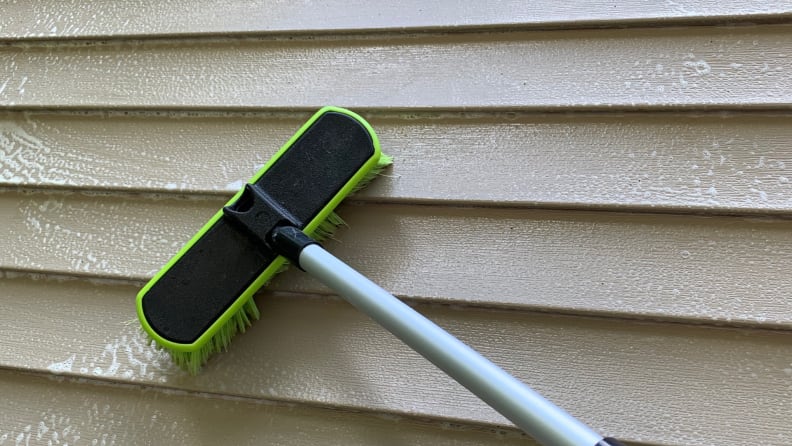 Using a garden hose, a cleaner, and a soft bristled brush is a gentle but effective way to remove grunge from your vinyl siding.