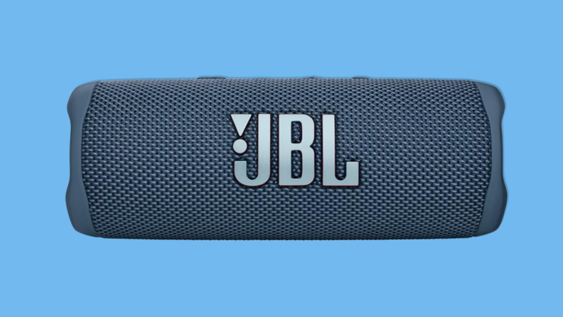 JBL Flip 6 portable Bluetooth speaker on blue background.