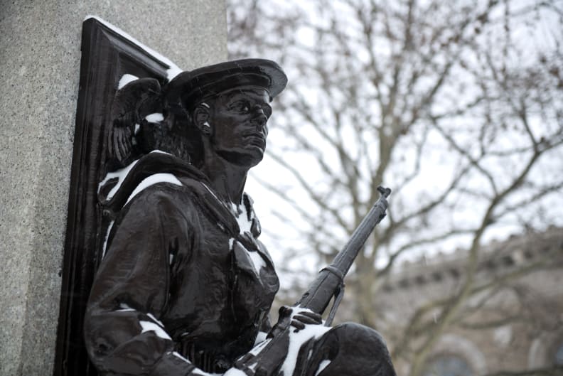 A photo of a statue of a soldier taken during winter storm Juno.