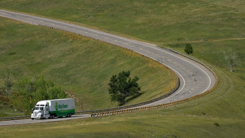 A semi‑truck traveling along a scenic countryside road